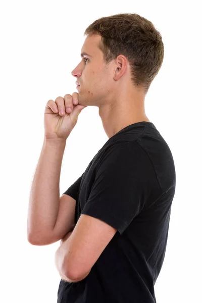Profil bild av ung man tänker med hand på hakan — Stockfoto
