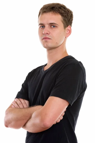 Studio shot of young man with arms crossed — Stock Photo, Image