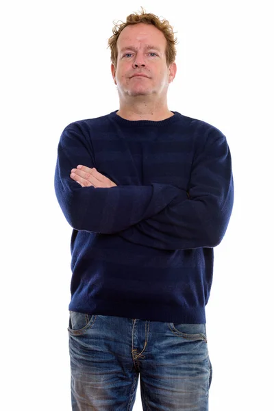 Studio shot of mature man with curly hair standing with arms cro — Stock Photo, Image
