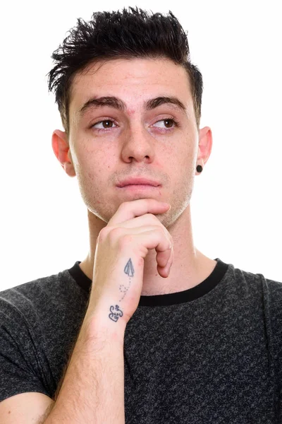 Face of young man thinking while looking at distance — Stock Photo, Image