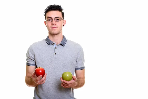 Estudio de un joven sosteniendo manzana roja y verde — Foto de Stock