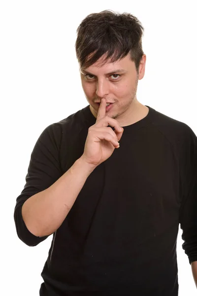 Studioaufnahme eines verrückten Kaukasiers mit Finger auf den Lippen — Stockfoto