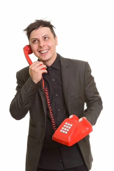 Estúdio tiro de feliz homem de negócios caucasiano falando por telefone — Fotografia de Stock