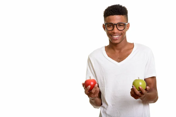 Young happy African man holding red and  green apple — Stock Photo, Image