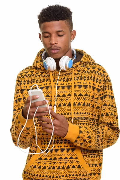 Young handsome African man using mobile phone while wearing head — Stock Photo, Image