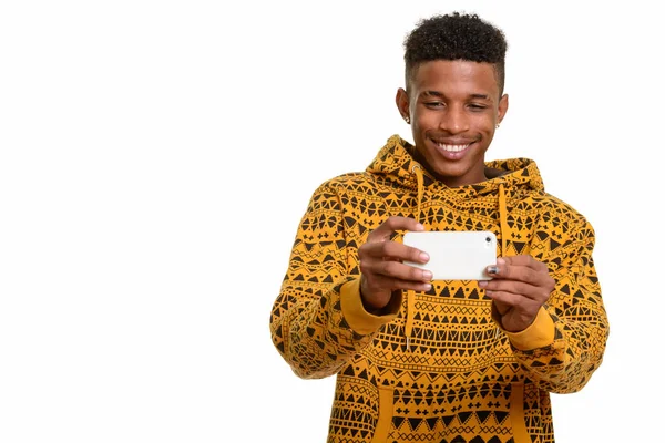 Young happy African man taking picture with mobile phone — Stock Photo, Image
