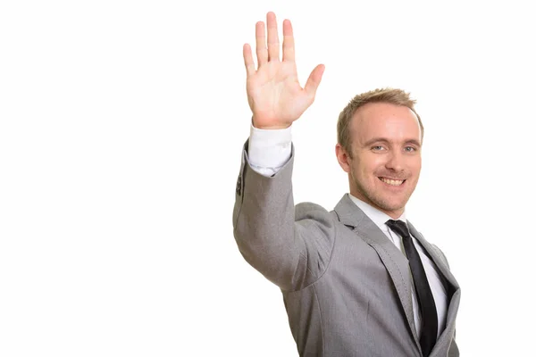 Happy handsome Caucasian businessman raising hand — Stock Photo, Image