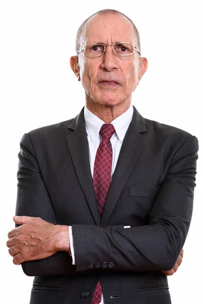 Studio shot of angry senior businessman with arms crossed — Stock Photo, Image