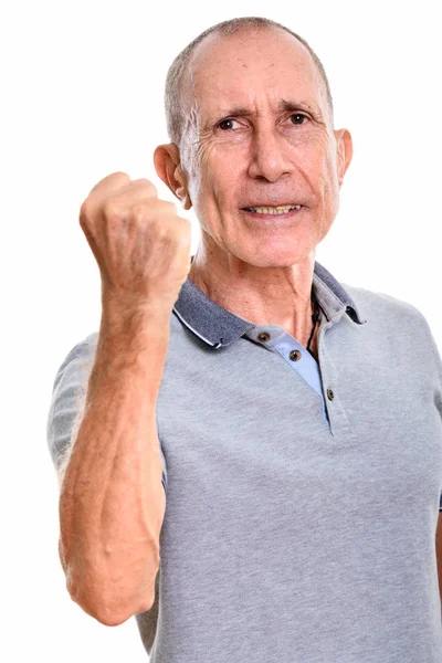 Studio shot of angry senior man with arm raised — Stock Photo, Image