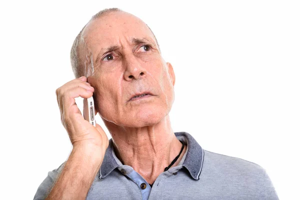 Close up of senior man talking on mobile phone while thinking — Stock Photo, Image