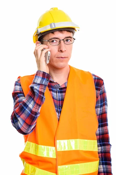 Studio shot of thoughtful man construction worker talking on mob — Stock Photo, Image