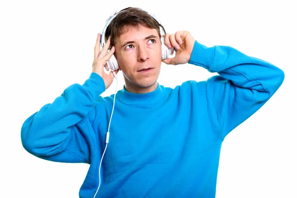 Düşünceli adam kulaklık ile tutarak müzik — Stok fotoğraf