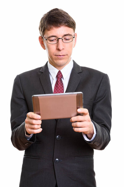 Studio shot of businessman holding digital tablet