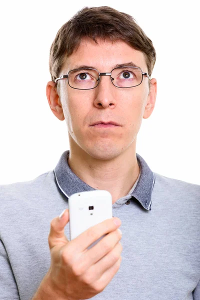 Gesicht des Mannes, der beim Denken sein Handy in der Hand hält — Stockfoto