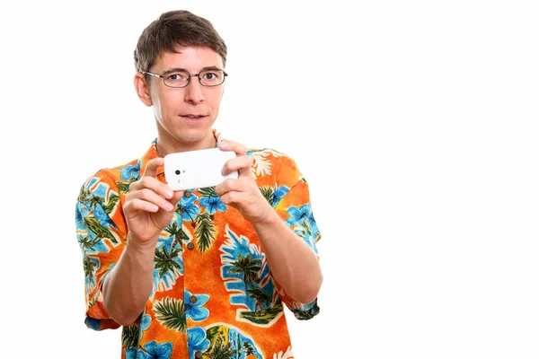 Studio shot of man taking picture with mobile phone — Stock Photo, Image