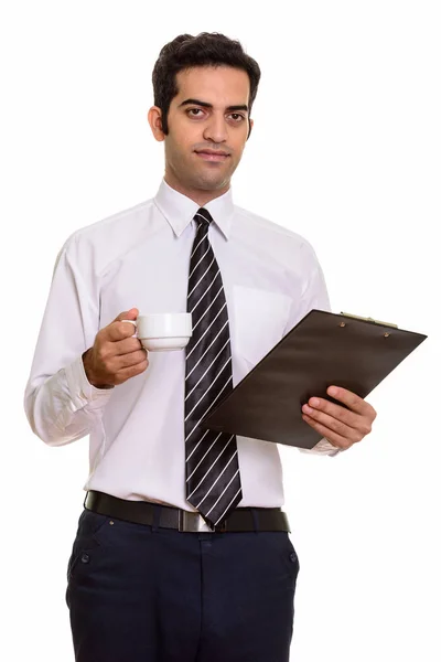Young Persian businessman holding clipboard and coffee cup — Stock Photo, Image
