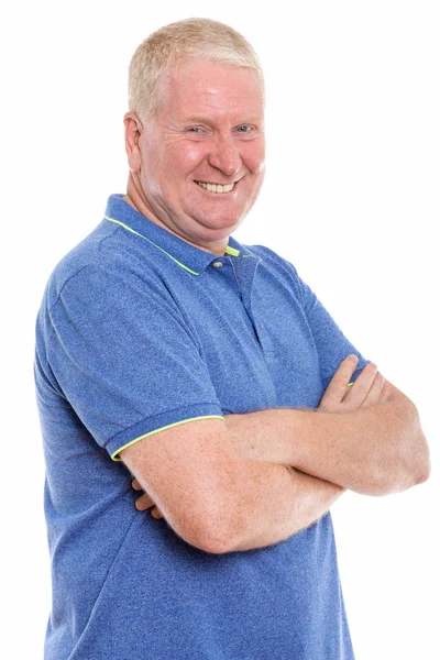 Studio shot of happy mature man smiling with arms crossed — Stock Photo, Image