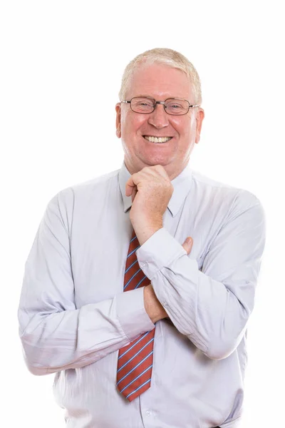 Studio shot of happy mature businessman smiling while thinking a — Stock Photo, Image