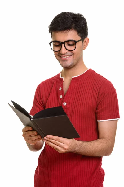 Young happy Persian man reading book — Stock Photo, Image