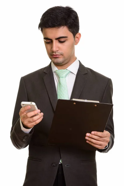 Giovane bell'uomo d'affari persiano che tiene appunti durante l'utilizzo — Foto Stock