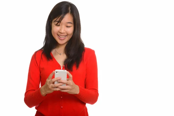 Young happy Asian woman using mobile phone — Stock Photo, Image