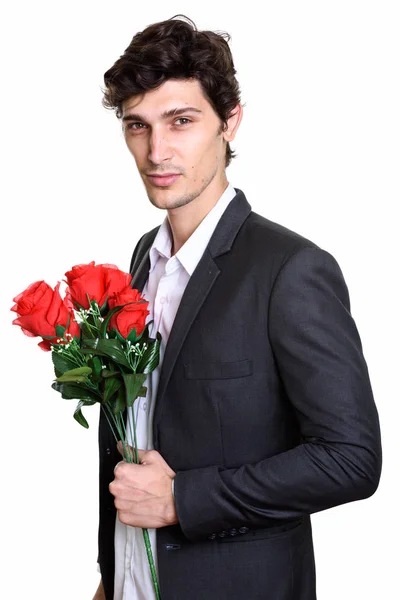 Stúdió lövés fiatal jóképű üzletember kezében vörös rózsa — Stock Fotó