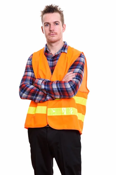 Студийный снимок рабочего-строителя, стоящего с крестом — стоковое фото