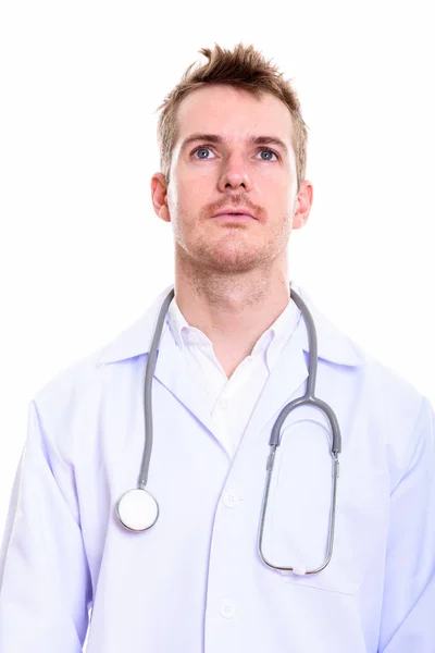 Studio shot of man doctor thinking — Stock Photo, Image