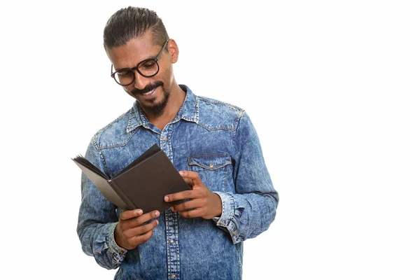 Young happy Indian man reading book — Stock Photo, Image