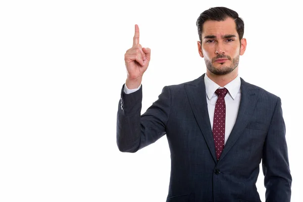 Estúdio tiro de jovem empresário bonito apontando dedo para cima — Fotografia de Stock