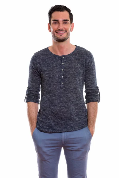 Studio shot of happy young handsome man smiling while standing w — Stock Photo, Image