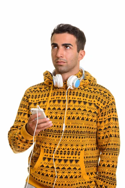 Young handsome Caucasian man holding mobile phone and wearing he — Stock Photo, Image