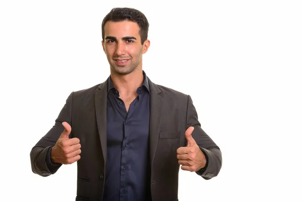 Молодой счастливый кавказский бизнесмен подает большие пальцы — стоковое фото