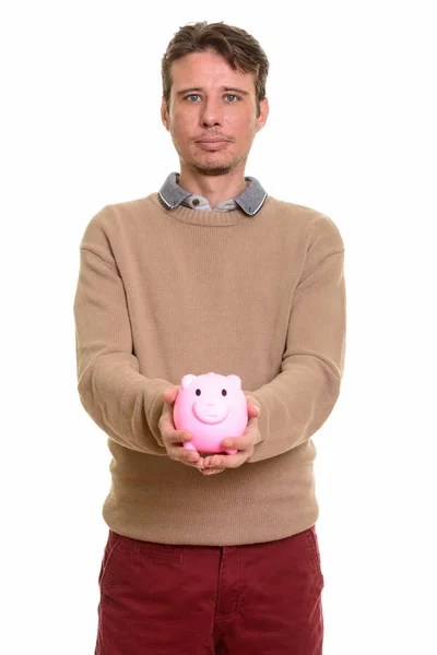 Piggy bank holding jóképű kaukázusi Férfi — Stock Fotó
