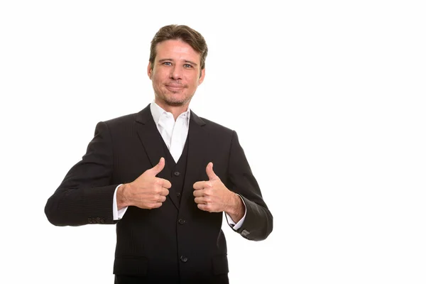 Handsome Caucasian businessman giving thumbs up — Stock Photo, Image
