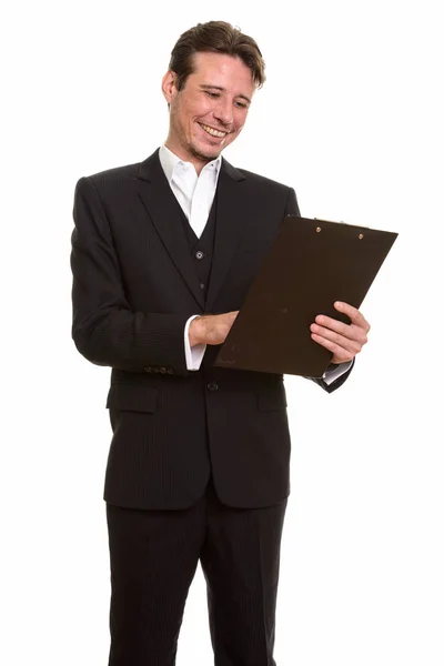 Happy Caucasian businessman reading clipboard — Stock Photo, Image