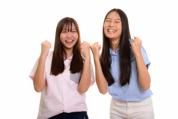 Two young happy Asian teenage girls smiling and both looking mot — Stock Photo, Image