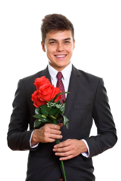 Pemuda bahagia pengusaha tersenyum sambil memegang mawar merah siap fo — Stok Foto