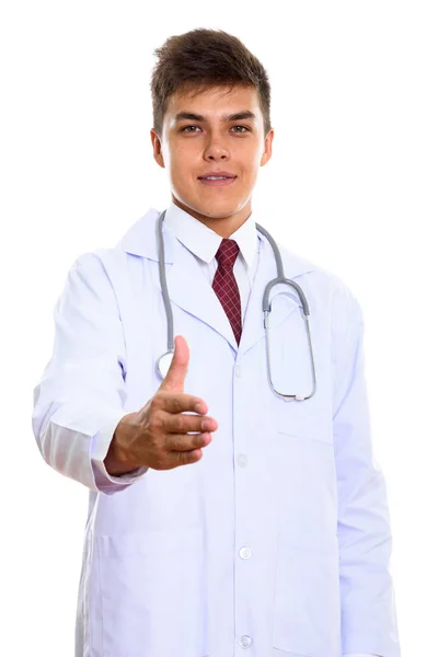 Studio shot of young handsome man doctor giving handshake — Stock Photo, Image