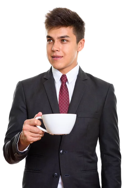 Studio shot of young handsome businessman holding coffee cup whi — Stock Photo, Image
