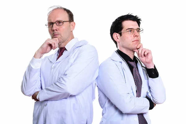 Mature man doctor and young man doctor thinking together — Stock Photo, Image