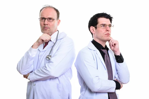 Mature homme médecin et jeune homme médecin penser ensemble — Photo