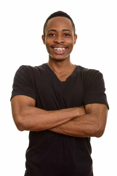 Jonge gelukkige Afrikaanse man lacht met gekruiste armen — Stockfoto