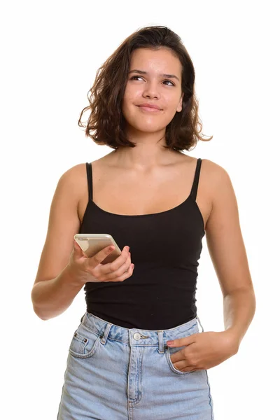 Joven hermosa caucásica adolescente celebración de teléfono móvil whil —  Fotos de Stock