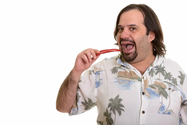Fat Caucasian man ready to bite spicy chili pepper — Stock Photo, Image