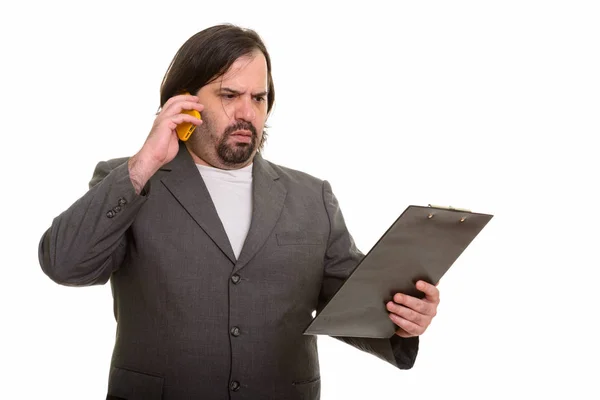 Gordo caucásico hombre de negocios buscando confundido mientras habla en phon — Foto de Stock