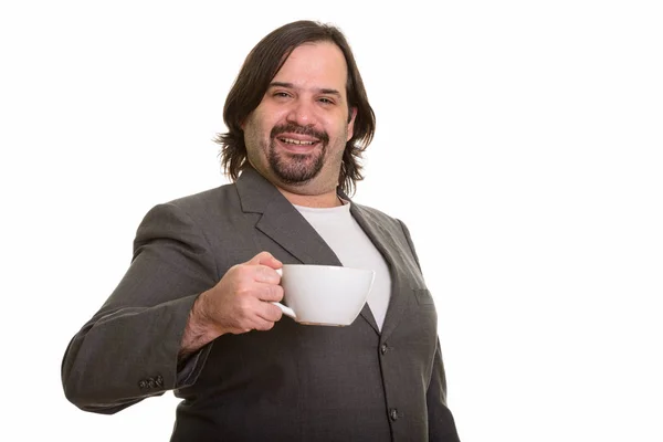 幸せな脂肪白人実業家笑顔と保持コーヒーカップ — ストック写真