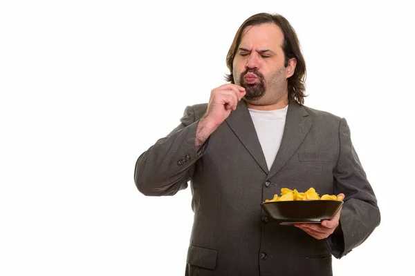 Een dikke blanke zakenman die heerlijk friet eet. — Stockfoto