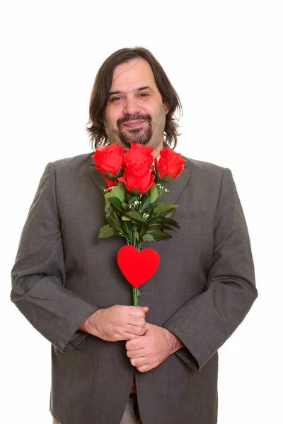 Feliz gordo caucásico hombre de negocios sonriendo sosteniendo rosas rojas y él —  Fotos de Stock