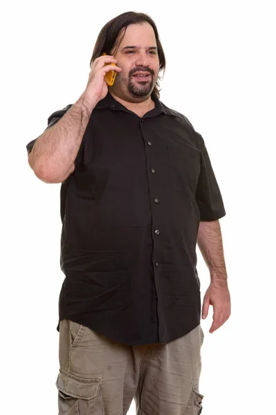 Happy fat Caucasian man smiling and talking on mobile phone — Stock Photo, Image